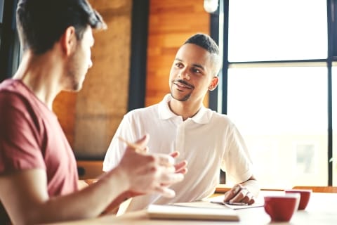 Two people looking at each other and talking