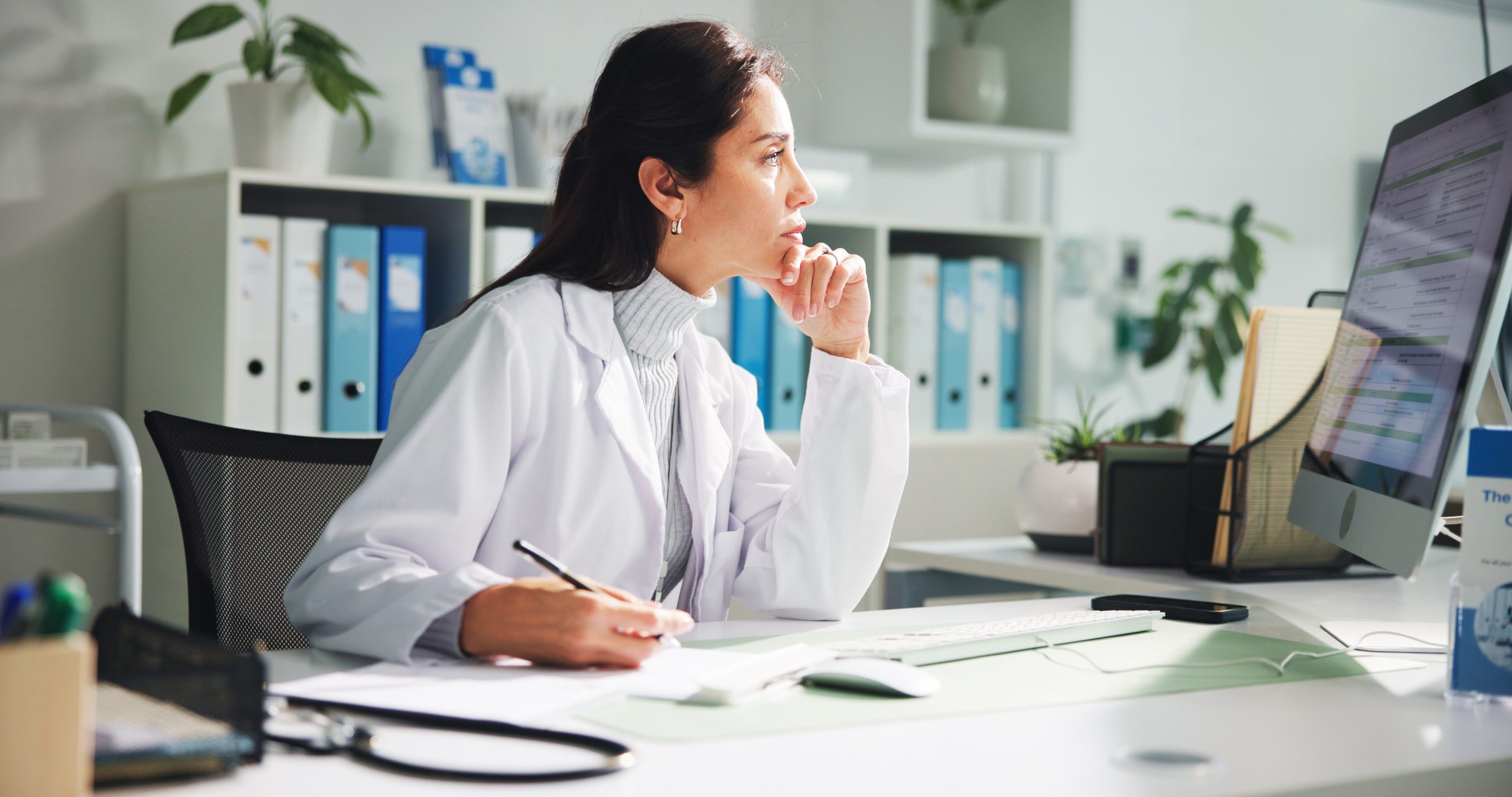 Computer, woman and doctor thinking with report in clinic for research, diagnosis or treatment. Tech, medical service and female healthcare worker with document for paperwork in hospital office.